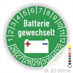Prüfetiketten, Prüfplakette rund, Farbe- Grün, Text "Batterie gewechselt" in Weiß. Icon Batterie, Startjahr- 26, Monatszahlen Oben und Jahreszahlen Unten in Kreisform.
