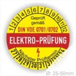 Prüfplaketten rund, Farbe- Gelb in der Mitte ein Streifen in Rot, Text oberer Teil "Geprüft gemäß DIN VDE 0701/0702" in Schwarz. Mittig Streifen in Rot mit dem Text " ELEKTRO-PRÜFUNG", danach Elektropfeil in Rot Startjahr- 27, Monatszahlen Oben und Jahreszahlen Unten in Kreisform. Über den Jahreszahlen Text "Nächster Prüftermin"