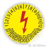 Runde gelbe Elektro-Check Prüfplakette mit rotem Blitzsymbol, Monatsring und Jahresring sowie Aufdruck „Nächster Prüftermin“, Ø 20–50 mm
