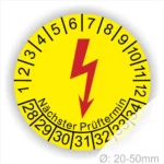 Gelbes Prüfplakett mit Blitzsymbol, das den nächsten Prüftermin anzeigt, geeignet für elektrische Geräte mit einem Durchmesser von 20-50 mm.
