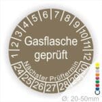 Prüfplaketten, Prüfetikette rund, Farbe- Braun, Text "Gasflasche geprüft" in Weiß. Startjahr- 24, Monatszahlen Oben und Jahreszahlen Unten in Kreisform. Über den Jahreszahlen Text "Nächster Prüftermin"