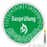 Prüfplaketten, Prüfetiketten rund, Farbe- Grün, Text "Gasprüfung" in Weiß danach eine Flamme als Pictogramm oder Icon in Weiß, Startjahr- 26, Monatszahlen Oben und Jahreszahlen Unten in Kreisform. Über den Jahreszahlen Text "Nächster Prüftermin"