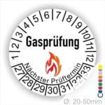 Prüfplaketten, Prüfetikette rund, Farbe- Weiß, Text "Gasprüfung" in Schwarz danach eine Flamme als Pictogramm oder Icon in Rot, Startjahr- 27, Monatszahlen Oben und Jahreszahlen Unten in Kreisform. Über den Jahreszahlen Text "Nächster Prüftermin"