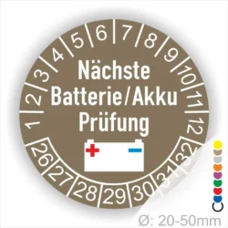 Batterie Akku Prüfung Prüfplaketten rund, Farbe- Gelb, Text "Nächste Batterie/Akku Prüfung" in Schwarz. Icon Batterie, Startjahr- 26, Monatszahlen Oben und Jahreszahlen Unten in Kreisform.