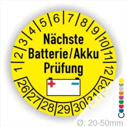 Gelbes Prüfetikett für die nächste Batterie- oder Akkuprüfung, mit einem Symbol für eine Batterie und nummerierten Prüfintervallen von 1 bis 12 und Jahreszahlen 26 bis 32. Ideal für die Kennzeichnung von Wartungsfristen.