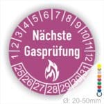 Prüfplaketten rund, Farbe- Lila, Text "Nächste Gasprüfung" in Weiß danach eine Flamme als Pictogramm oder Icon in Weiß, Startjahr- 25, Monatszahlen Oben und Jahreszahlen Unten in Kreisform.