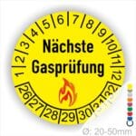 Prüfplaketten, Prüfetiketten rund, Farbe- Weiß, Text "Nächste Gasprüfung" in Schwarz danach eine Flamme als Pictogramm oder Icon in Rot, Startjahr- 26, Monatszahlen Oben und Jahreszahlen Unten in Kreisform. Über den Jahreszahlen.