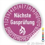 Prüfetiketten, Prüfplaketten rund, Farbe- Lila, Text "Nächste Gasprüfung" in Weiß danach eine Flamme als Pictogramm oder Icon in Weiß, Startjahr- 26, Monatszahlen Oben und Jahreszahlen Unten in Kreisform.