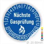Runder Aufkleber in Blau zur Kennzeichnung der nächsten Gasprüfung mit Feuer-Icon und Zahlen von 1 bis 12 Monatszahlen und 27-33 Jahreszahlen. Ideal für die Sicherheit von Gasinstallationen. Durchmesser 20-50 mm.
