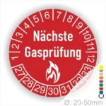 Runder Aufkleber mit der Aufschrift "Nächste Gasprüfung", der zur Kennzeichnung von Gasprüfungen verwendet wird. Der Aufkleber ist rot und hat eine Durchmessergröße von 20-50 mm.