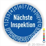 Runder Aufkleber zur Anzeige des nächsten Inspektionsdatums, blau mit weißen Zahlen von 1 bis 12 und Jahreszahlen 27-33, Durchmesser von 20-50 mm.