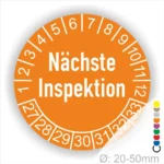 Runder Aufkleber zur Anzeige des nächsten Inspektionsdatums, orange mit weißen Zahlen von 1 bis 12 und Jahreszahlen 27-33, Durchmesser von 20-50 mm.