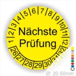 Prüfplaketten, Prüfetiketten rund, Farbe- gelb, Text "Nächste Prüfung" in schwarz. Startjahr- 26, Monatszahlen Oben und Jahreszahlen Unten in Kreisform.