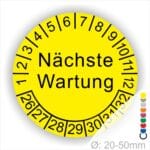 Prüfplaketten, Prüfetiketten rund, Farbe- Gelb, Text "Nächste Wartung" in Schwarz. Startjahr- 26, Monatszahlen Oben und Jahreszahlen Unten in Kreisform.