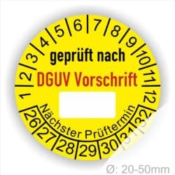 Prüfplakette rund mit Text geprüft nach DGUV Vorschrift danach Beschriftungsfeld in Weiß und Text Nächster Prüftermin. Plaketten Farbe- Gelb und Text in schwarz ausser DGUV Vorschrift in Rot. Monatszahlen oben und Jahreszahlen unten beginnend mit Startjahr- 26, Durchmesser 20-50mm frei wählbar.