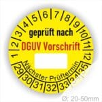 Prüfplakette rund mit Text geprüft nach DGUV Vorschrift danach Beschriftungsfeld in Weiß und Text Nächster Prüftermin. Plaketten Farbe- Gelb und Text in schwarz ausser DGUV Vorschrift in Rot. Monatszahlen oben und Jahreszahlen unten beginnend mit Startjahr- 29, Durchmesser 20-50mm frei wählbar.