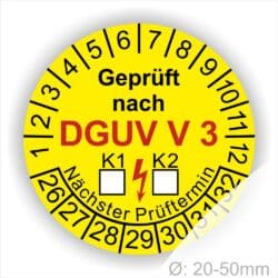 Prüfplakette rund mit Text geprüft nach DGUV Vorschrift 3 danach Ankreuzfeld K1 K2 in Weiß und Text Nächster Prüftermin. Plaketten Farbe- Gelb und Text in Schwarz ausser DGUV in Rot. Monatszahlen oben und Jahreszahlen unten beginnend mit Startjahr- 26. Durchmesser 20-50mm frei wählbar.