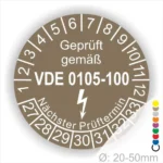 Prüfsiegel gemäß VDE 0105-100, zeigt den nächsten Prüftermin und die Prüfziffern für elektrische Geräte im Durchmesser von 20-50 mm.
