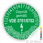 Grünes Prüfzeichen für elektrische Geräte, geprüft gemäß VDE 0701/0702, mit Angaben zum nächsten Prüftermin und Durchmesser von 20-50mm.
