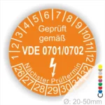 Prüfsiegel für elektrische Geräte gemäß VDE 0701/0702, orangefarbener Aufkleber mit Prüftermin und Durchmesserangabe von 20-50 mm.