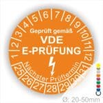 Prüfplaketten rund, Text "geprüft gemäß VDE E-Prüfung" Farbe- Orange Startjahr- 25 mit Elektro Pfeil, Monatszahlen Oben und Jahreszahlen Unten