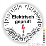 Rundes Etikett mit der Aufschrift "Elektrisch geprüft" und einem Blitzsymbol. Zeigt den nächsten Prüftermin an, um Sicherheitsstandards für elektrische Geräte zu gewährleisten. Durchmesser von 20-50 mm.