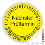 Mehrjahresplakette Prüfplakette rund, Farbe- Gelb, Text "Nächster Prüftermin" in Schwarz. Startjahr- 26, Monatszahlen Oben und Jahreszahlen Unten in Kreisform.