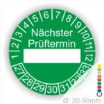 Prüfplakette, Prüfetikett rund, Farbe- Grün, Text "Nächster Prüftermin" in Weiß. Als nächstes kommt ein Beschriftung Feld / Leer Feld in Farbe Weiß. Startjahr- 27, Monatszahlen Oben und Jahreszahlen Unten in Kreisform.