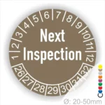 Prüfplaketten, Prüfaufkleber rund, Farbe- braun, Text auf Englisch "Next Inspection" in Weiss. Startjahr- 26, Monatszahlen Oben und Jahreszahlen Unten in Kreisform.