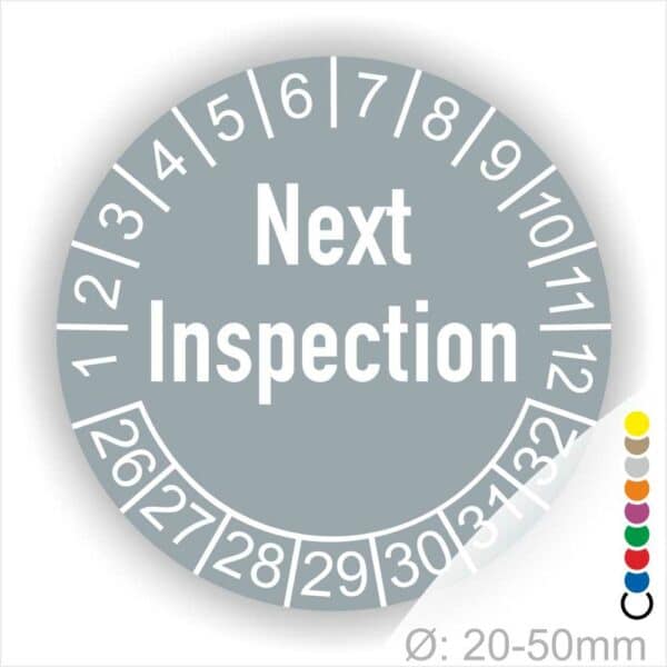 Prüfetiketten, Prüfaukleber rund, Farbe- Grau, Text auf Englisch "Next Inspection" in Weiß. Startjahr- 26, Monatszahlen Oben und Jahreszahlen Unten in Kreisform.