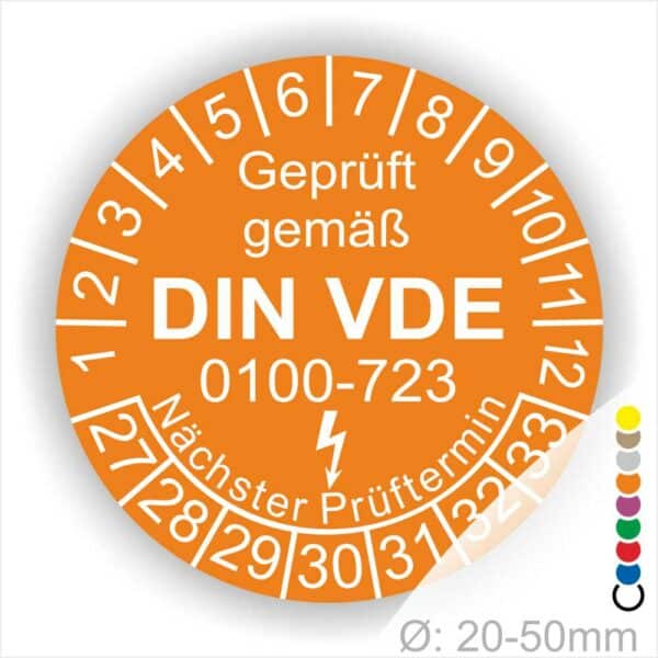 Prüfaufkleber rund, Farbe- Orange, Text "Geprüft gemäß VDE 0100-0723" in Weiß danach ein Elektro- Pfeil in Weiß, Startjahr- 27, Monatszahlen Oben und Jahreszahlen Unten in Kreisform. Über den Jahreszahlen Text "Nächster Prüftermin"