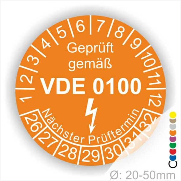 Prüfplaketten rund Farbe- Orange, Text "Geprüft gemäß VDE 0100" in Weiß danach ein Elektro- Pfeil in Weiß, Startjahr- 26, Monatszahlen Oben und Jahreszahlen Unten in Kreisform. Über den Jahreszahlen Text "Nächster Prüftermin"