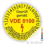 Runde gelbe Prüfplakette „Geprüft gemäß VDE 0100“ mit Monatsring und Jahresring, Blitzsymbol und Aufdruck „Nächster Prüftermin“, Ø 20–50 mm