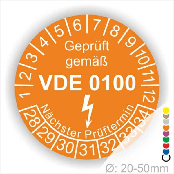 Prüfetikette rund, Farbe- Orange, Text "Geprüft gemäß VDE 0100" in Weiß danach ein Elektro- Pfeil in Weiß, Startjahr- 28, Monatszahlen Oben und Jahreszahlen Unten in Kreisform. Über den Jahreszahlen Text "Nächster Prüftermin"