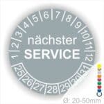 Prüfplaketten, Prüfetiketten rund, Farbe- Grau, Text "nächster SERVICE" in Weiß. Startjahr- 25, Monatszahlen Oben und Jahreszahlen Unten in Kreisform.