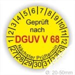Prüfplakette, Prüfsiegel rund mit Text geprüft nach Dguv Vorschrift 68 danach Nächster Prüftermin. Plaketten Farbe- Gelb und Text in Schwarz . Monatszahlen oben und Jahreszahlen unten beginnend mit Startjahr- 27. Für Prüfungen von Flurförderzeuge