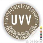 Prüfetikette rund, Farbe- Braun, Text "UVV" in Weiß. Startjahr- 26, Monatszahlen Oben und Jahreszahlen Unten in Kreisform. Über den Jahreszahlen Text "Nächster Prüftermin". Die Prüfplakette wird verwendet zur Prüfung von Anlagen & Maschinen