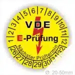 VDE E-Prüfungsaufkleber mit nächstem Prüftermin, gelb, für Geräte mit einem Durchmesser von 20-50 mm, zeigt Prüfintervalle und Sicherheitsinformationen.