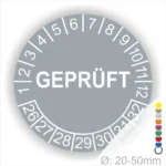 Rundschild mit der Aufschrift "GEPRÜFT" und Zahlen von 1 bis 32, geeignet für Durchmesser von 20-50 mm, in grauer Farbe.
