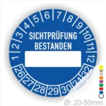 Prüfplakette, Prüfetikett rund, Farbe- Blau, Text "SICHTPRÜFUNG-BESTANDEN" in Weiß. Als nächstes kommt ein Beschriftung Feld / Leer Feld in Farbe Weiß. Startjahr- 26, Monatszahlen Oben und Jahreszahlen Unten in Kreisform.