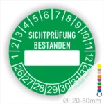 Prüfplakette, Prüfetikett rund, Farbe- Grün, Text "SICHTPRÜFUNG-BESTANDEN" in Weiß. Als nächstes kommt ein Beschriftung Feld / Leer Feld in Farbe Weiß. Startjahr- 26, Monatszahlen Oben und Jahreszahlen Unten in Kreisform.