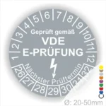 VDE E-Prüfungsplakette mit Prüfintervall und nächstem Prüftermin, Durchmesser 20-50 mm, zur Kennzeichnung elektrischer Geräte und Sicherheit.