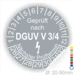 Prüfsiegel für DGUV V 3/4 mit Angaben zum nächsten Prüftermin und Durchmesser von 20-50 mm, auf grauem Hintergrund.