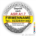 Prüfsiegel gemäß ASR A1.7 mit Firmenname, Telefonnummer und nächstem Prüftermin. Das Siegel zeigt einen Durchmesser von 25-50 mm und enthält wichtige Kontaktdaten sowie die Adresse der Firma.